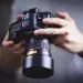 two hands holding a photo camera.