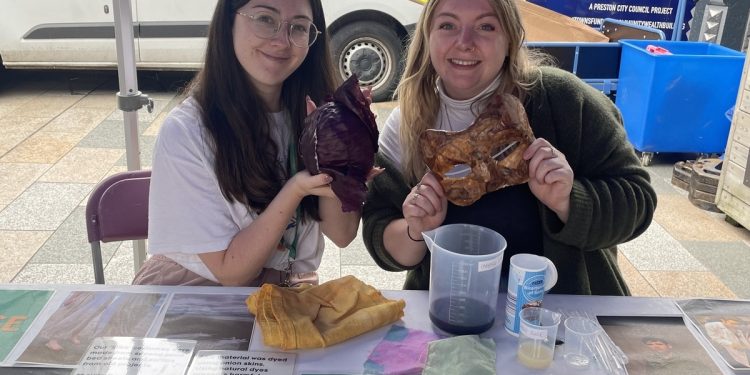 two women showing pieces of fabric they are staining