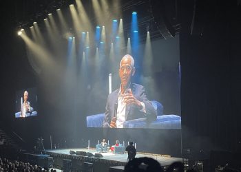 Former president Barak Obama on stage, and on large video screens